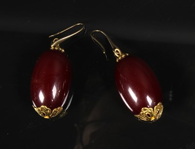 Lot 86 - A pair of cherry amber style earrings, 4cm...