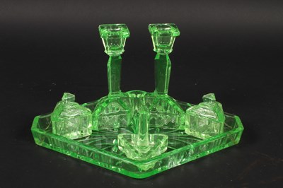 Lot 185 - A uranium glass dressing table set, including...