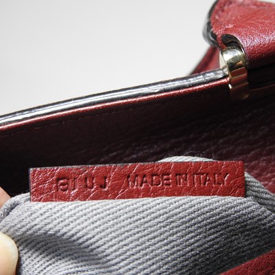 Lot 106 - A Cartier red leather handbag
