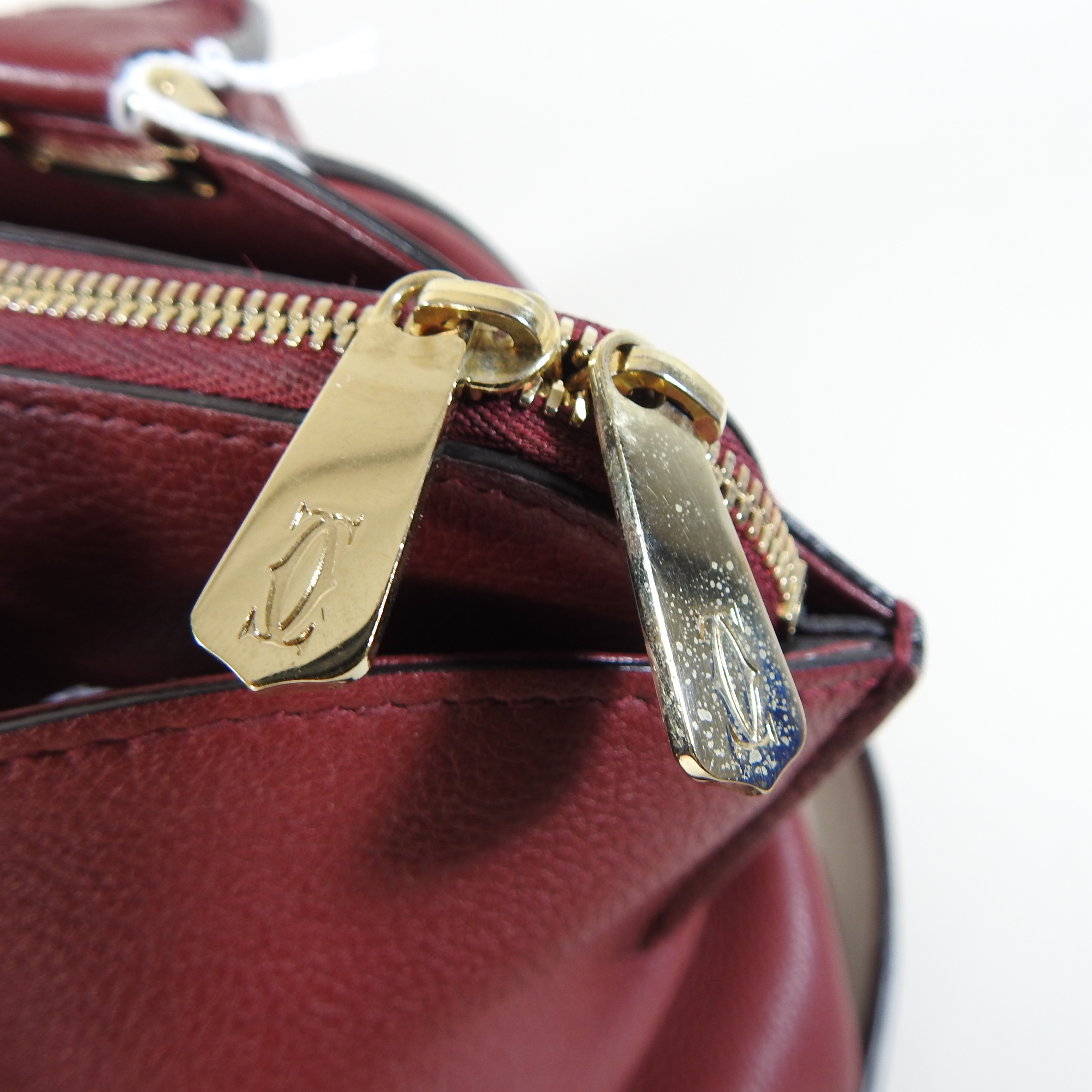Lot 106 - A Cartier red leather handbag,