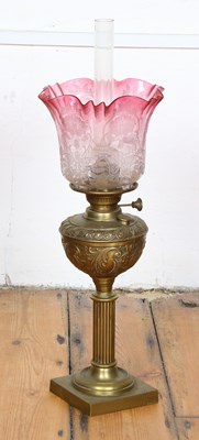 Lot 618 - A brass oil lamp, having a reeded column...