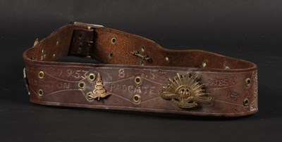 Lot 589 - A leather hate belt, with various military badges