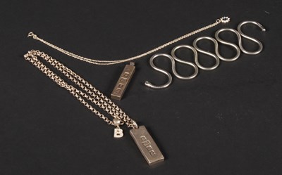 Lot 58 - A pair of silver ingot pendants, one on a...