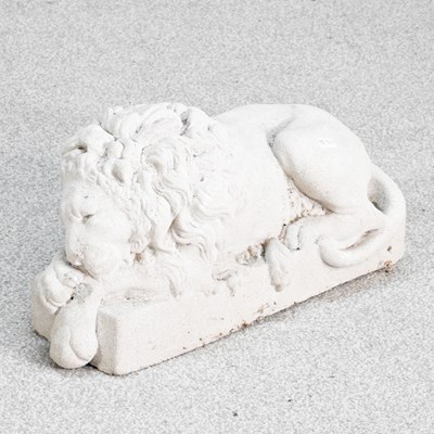 Lot 63 - A cast stone figure of a recumbent lion