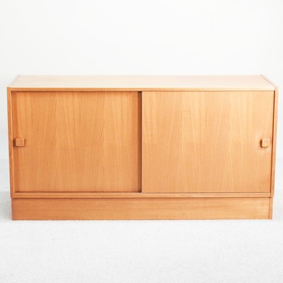 Lot 256 - A 1970's teak side cabinet, enclosed by...