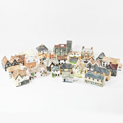 Lot 442 - A collection of pottery miniature cottages, to...