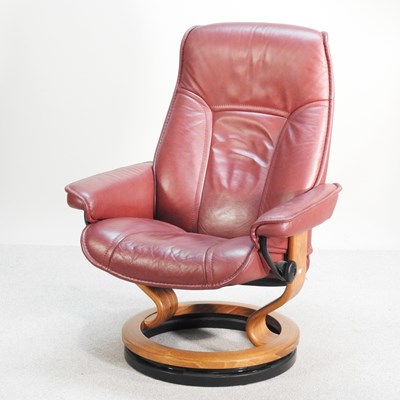 Lot 285 - A modern maroon leather reclining swivel armchair