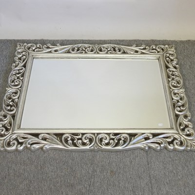 Lot 437 - A modern ornate silver painted wall mirror