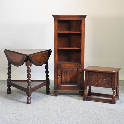 Lot 701 - An early 20th century carved oak drop leaf centre table