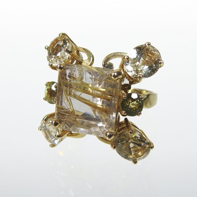 Lot 25 - An unmarked rutilated quartz seven stone cluster ring