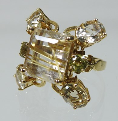 Lot 25 - An unmarked rutilated quartz seven stone cluster ring