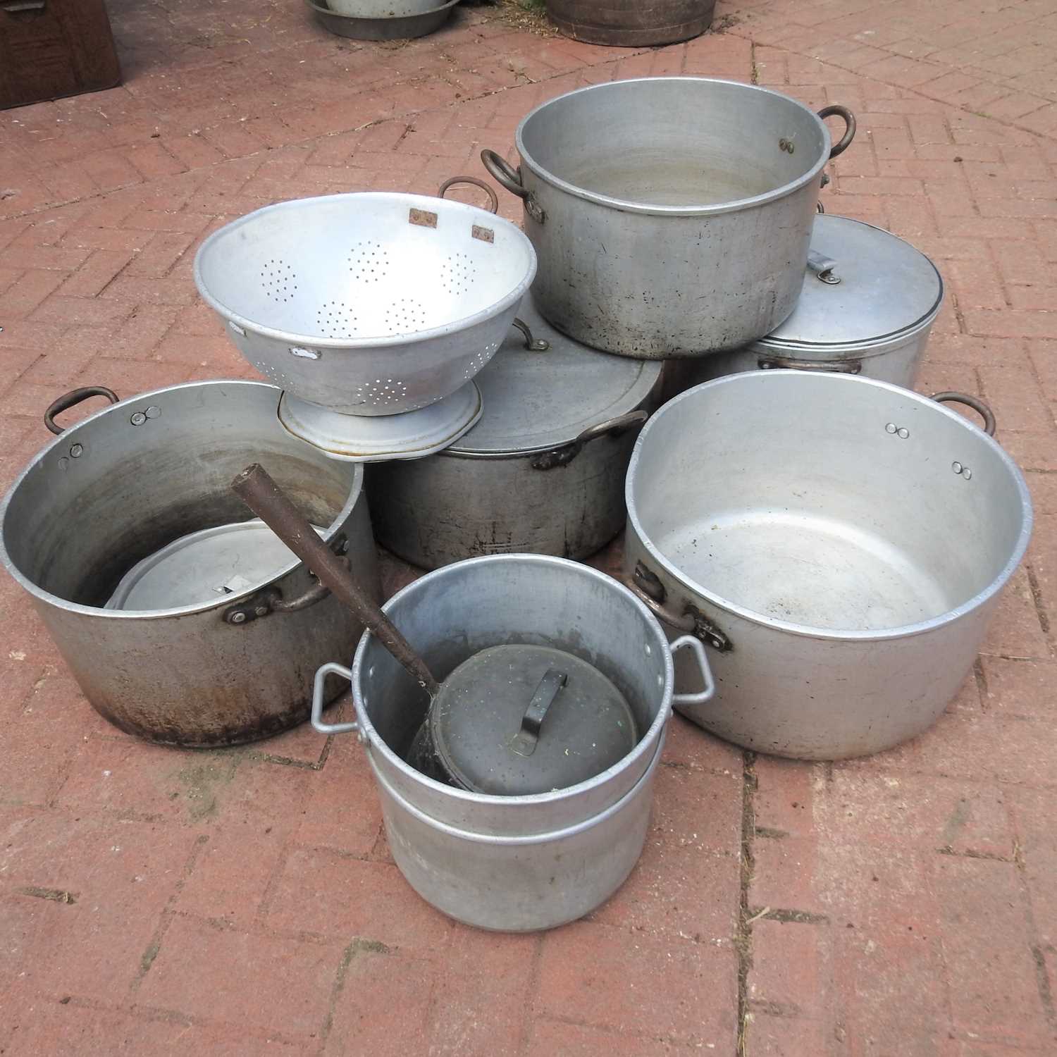 Lot 424 - A collection of large catering cooking pots