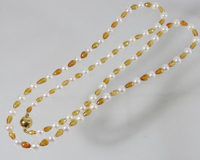 Lot 67 - A coloured cultured pearl necklace, with an 18 carat gold clasp