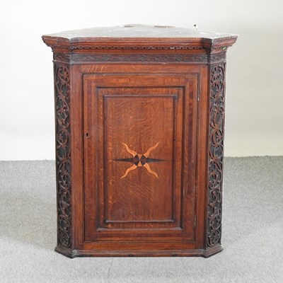 Lot 752 - A George III carved oak and inlaid corner cabinet