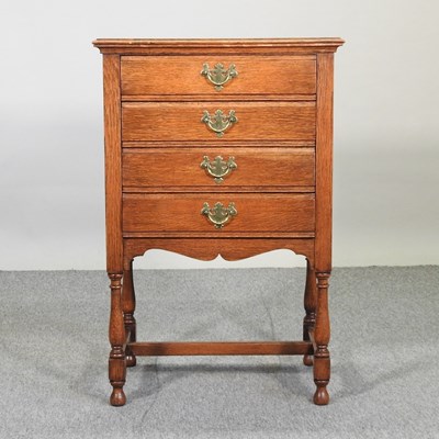 Lot 531 - An early 20th century oak music cabinet