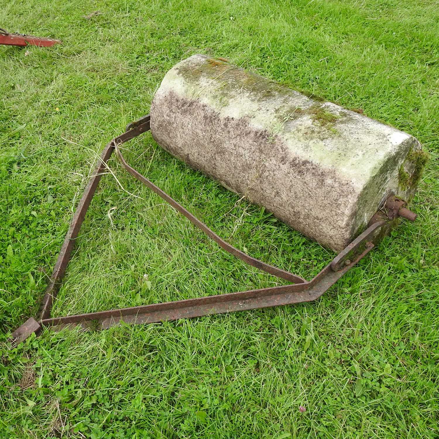 Lot 601 - A heavy flat stone roller, with an iron frame