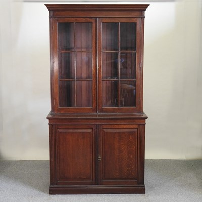 Lot 534 - An Edwardian oak cabinet bookcase