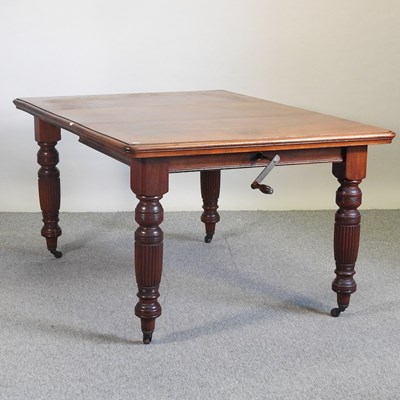 Lot 540 - A Victorian walnut wind out extending dining table