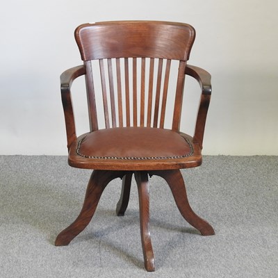 Lot 747 - An early 20th century oak desk chair