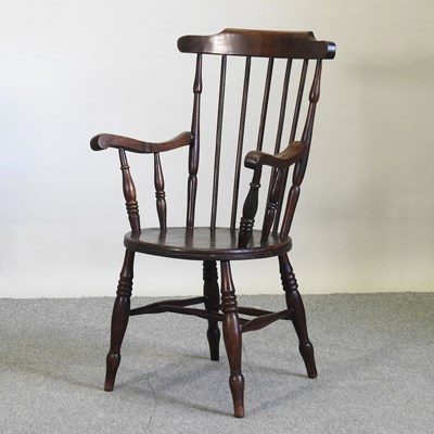 Lot 591 - An early 20th century spindle back armchair