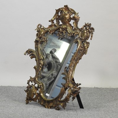 Lot 286 - An ornate brass framed easel mirror