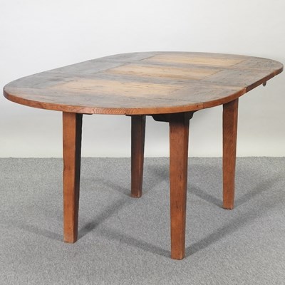 Lot 546 - A modern 19th century style oak pull out extending dining table