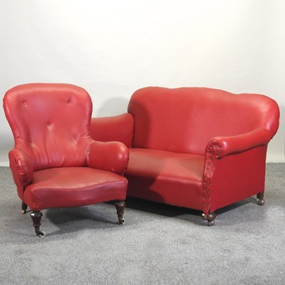 Lot 269 - A 1920's red vinyl upholstered sofa, 144cm, together with a matching armchair