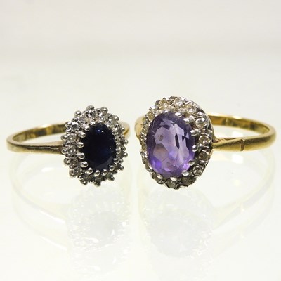 Lot 24 - An 18 carat gold amethyst and diamond cluster ring