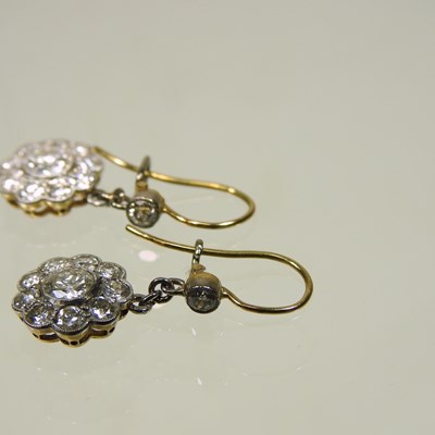 Lot 18 - A pair of unmarked two colour diamond cluster earrings