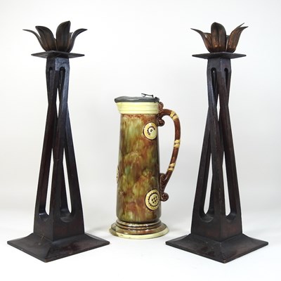 Lot 135 - A pair of Arts and Crafts style candlesticks