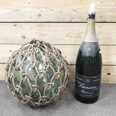 Lot 220 - A large glass fishing float, in a net