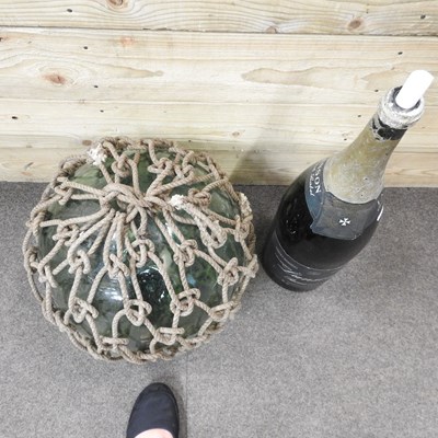 Lot 220 - A large glass fishing float, in a net