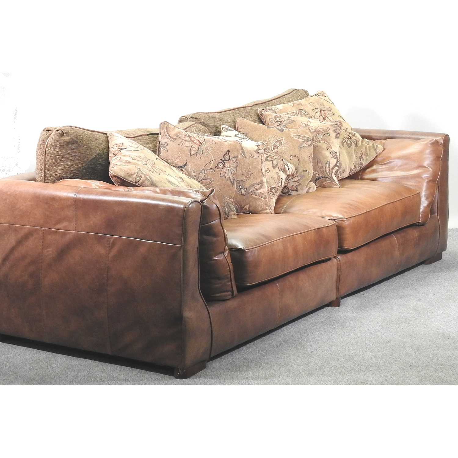 Lot 567 - A modern brown leather upholstered sofa