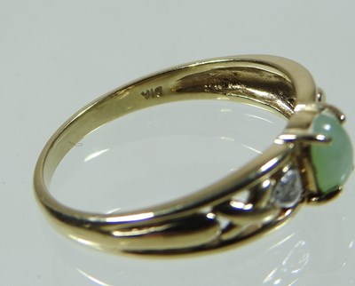 Lot 23 - A 9 carat gold diamond and jade ring