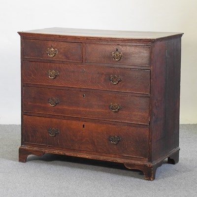 Lot 587 - A George III oak chest of drawers
