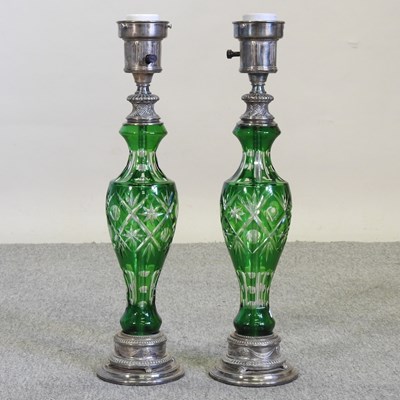 Lot 458 - A pair of metal and green cut glass table lamps