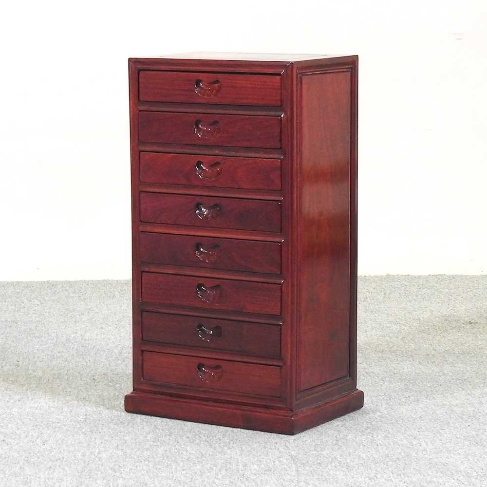 Lot 454 - A hardwood narrow chest of small proportions