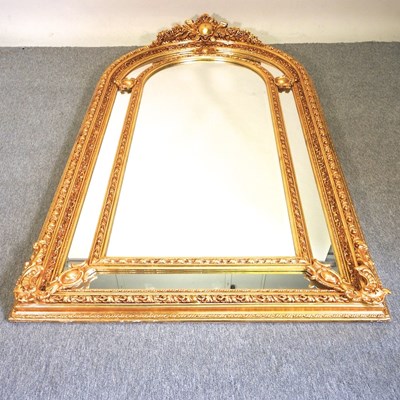 Lot 611 - An ornate modern gilt framed wall mirror