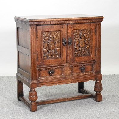 Lot 432 - An early 20th century carved oak cabinet