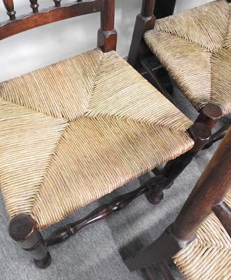 Lot 504 - A set of eight rush seated spindle back dining chairs