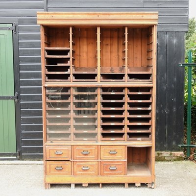 Lot 410 - A large early 20th century oak haberdashery cabinet