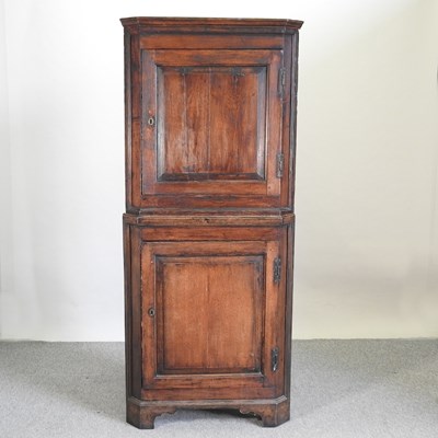 Lot 520 - A George III oak standing corner cabinet