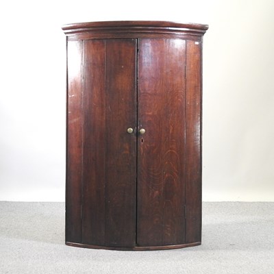 Lot 816 - A George III mahogany corner cupboard