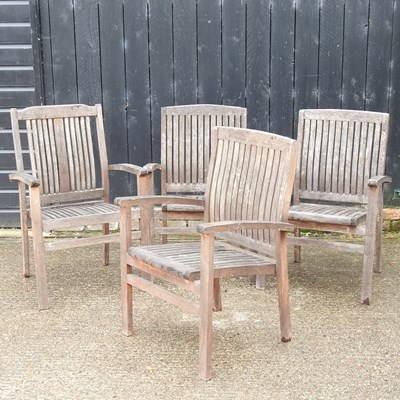 Lot 321 - A near set of four teak garden armchairs