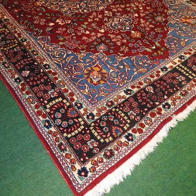 Lot 555 - A large Persian carpet