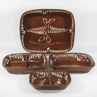 Lot 580 - A collection of four slipware baking trays