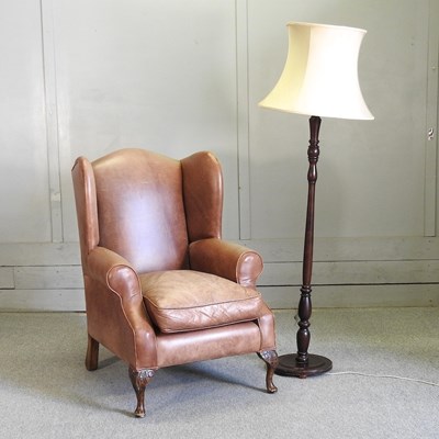 Lot 591 - A brown leather upholstered armchair