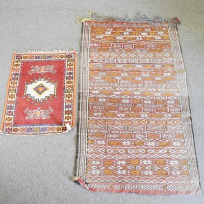 Lot 220 - A kelim rug, on a red ground