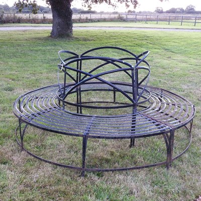 Lot 309 - A black painted iron circular tree bench