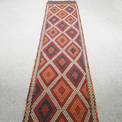 Lot 583 - A long kelim runner